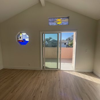 Infinite Flooring - an empty room with a stained glass window - Flooring Near Me