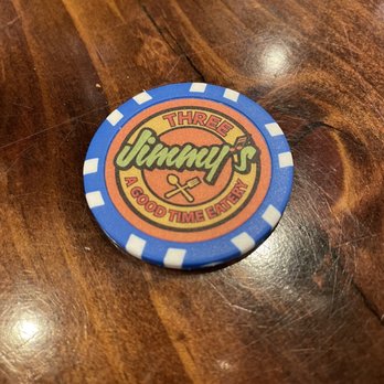 Three Jimmy's - a blue and orange chip on a wooden table - Burgers Near Me - Gatlinburg, Tennessee Three Jimmy's - a blue and orange chip on a wooden table - Burgers Near Me - Gatlinburg, Tennessee