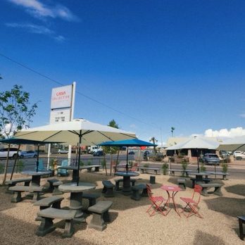 Casa Collective - a picnic area with tables and umbrellas - Food Trucks Near Me - Casa Grande, Arizona