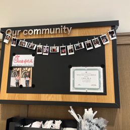 ows a bulletin board with pictures of people hanging on it ows a bulletin board with pictures of people hanging on it