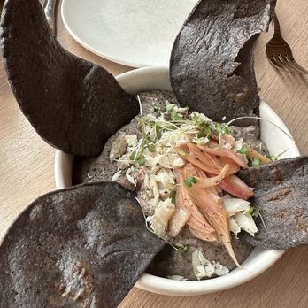 Owamni - The famous bean dip w white fish. Can barely taste the fish. Some pickled red onions, and what not on top, but you can barely taste them. - New American Near Me - Minneapolis, Minnesota