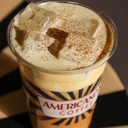 House-made sweet cream topping a drink at Americano's Coffee. Available in vanilla, strawberry, banana, salted caramel, and pistachio.