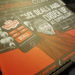 a pizza box with a man holding a cell phone a pizza box with a man holding a cell phone