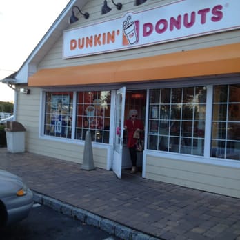 Dunkin' -  a man standing in front of a dunkin donuts store - Coffee & Tea Near Me - Wading River, New York