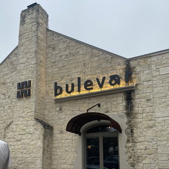 Bulevar Mexican Kitchen - The image shows the front of Bulevar Mexican Kitchen, with a stone exterior, a sign reading 'bulevar', and a chimney on the building. - Mexican Near Me - Austin, Texas