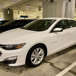 A white hybrid Malibu for our car rental