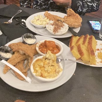 Kelsey's - Catfish with macaroni and cheese with yams . Basket of Cornbread. The other plate is fried pork chops white rice with gravy & potato salad - Soul Food Near Me - Atlantic City, New Jersey