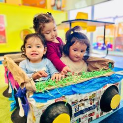 OC Kids Preschool & Kindergarten - Infant room playing together in a recycled car