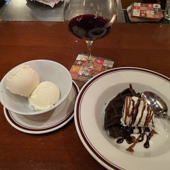Carlyle - A most delicious Flourless chocolate waffle cake with vanilla bean ice cream on the side.  I rarely order dessert but this us worth it! - New American Near Me - Arlington, Virginia