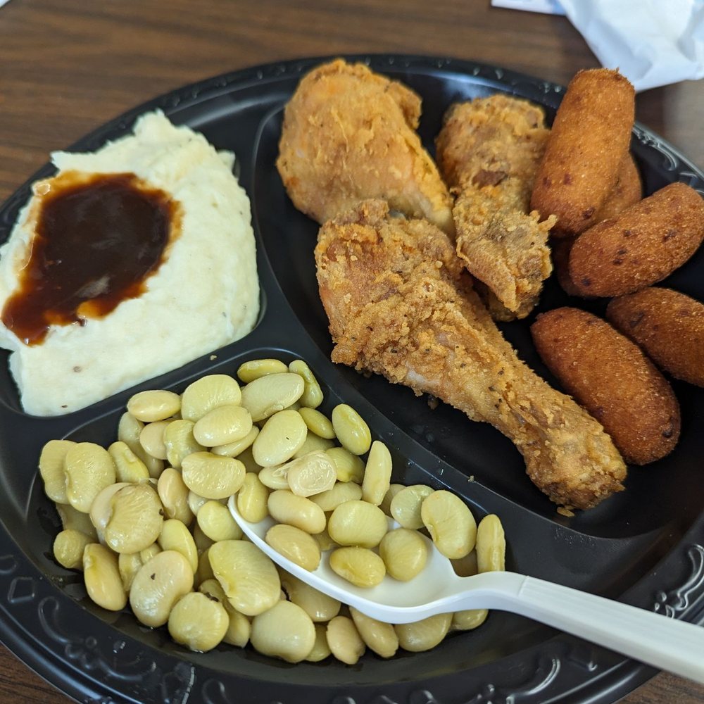 Fried chicken, lima beans, mashed potatoes and gravy, and hush puppies Fried chicken, lima beans, mashed potatoes and gravy, and hush puppies