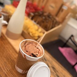 Rosetta Bakery - Swirl the hot cappuccino and cocoa powder