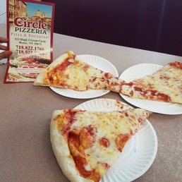three slices of pizza on paper plates