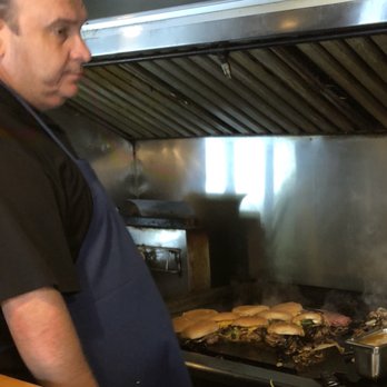 Nic's Grill - Justin "Nic" Nicholas at the grill preparing the first round of onion burgers for the day. - Burgers Near Me - Oklahoma City, Oklahoma Nic's Grill - Justin "Nic" Nicholas at the grill preparing the first round of onion burgers for the day. - Burgers Near Me - Oklahoma City, Oklahoma