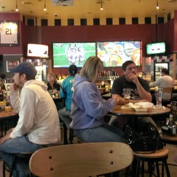 Buffalo Wild Wings - a group of people sitting at tables in a restaurant - Chicken Wings Near Me - Mason City, Iowa