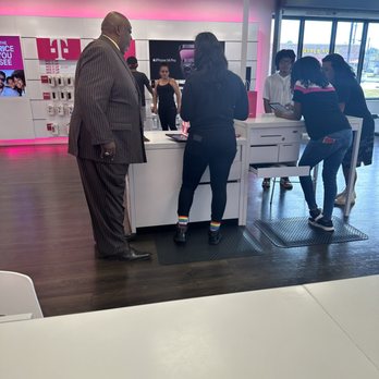 T-Mobile - Both associates with back turned. Aisha in the rainbow socks. - Mobile Phones Near Me - Decatur, Georgia