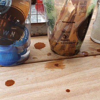 First Watch - A photo of the creamers at one of their patio table, the note how much water is in there, and it did not rain this morning either - Breakfast & Brunch Near Me - Orlando, Florida