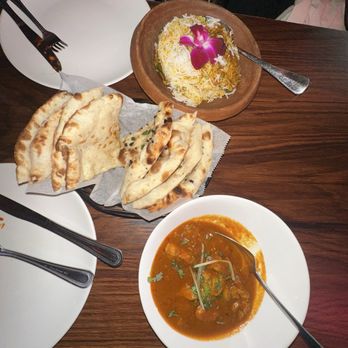 Curry In Handi - Lamb Biryani on top, goat cheese Naan and Chili Olive Naan, and Ginger Chicken on the bottom. - Halal Near Me - Brooklyn, New York