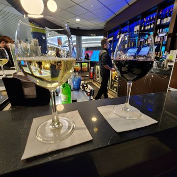 Bubbles - two glasses of wine on a bar - Wine Bars Near Me - Chicago, Illinois Bubbles - two glasses of wine on a bar - Wine Bars Near Me - Chicago, Illinois