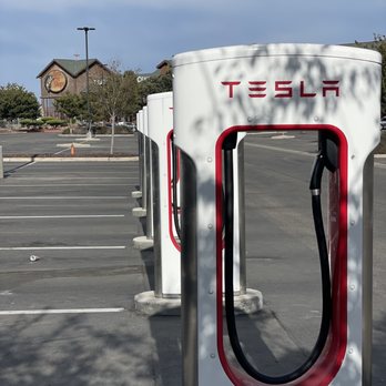 Tesla Supercharger - Manteca - Chargers with Bass Pro Shop in the distance - EV Charging Stations Near Me - Manteca, California Tesla Supercharger - Manteca - Chargers with Bass Pro Shop in the distance - EV Charging Stations Near Me - Manteca, California