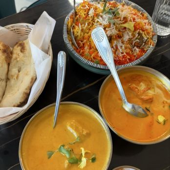 Daddy Ji Finest Indian Cuisine - Garlic and plain naan, butter chicken, chicken coconut curry, and goat biryani - Indian Near Me - Claremont, California