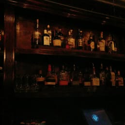 shelves of liquor bottles and a laptop shelves of liquor bottles and a laptop