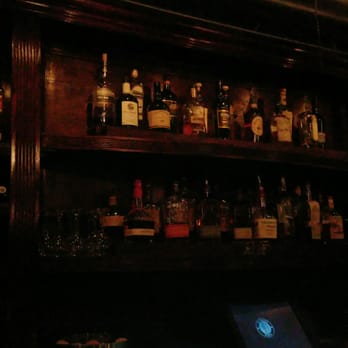 Black Lion Lounge - shelves of liquor bottles and a laptop - Pubs Near Me - Chicago, Illinois Black Lion Lounge - shelves of liquor bottles and a laptop - Pubs Near Me - Chicago, Illinois
