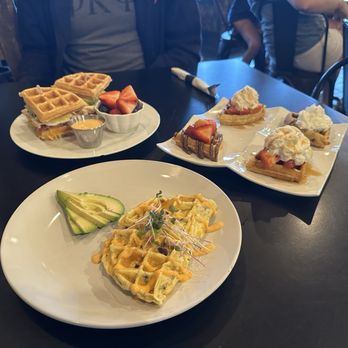 Re:Bar Cafe and Juicestillery - Womelette Ham (foreground), Carrie Dean Sammie (background left), waffle flight (background right) - Breakfast & Brunch Near Me - Tomball, Texas Re:Bar Cafe and Juicestillery - Womelette Ham (foreground), Carrie Dean Sammie (background left), waffle flight (background right) - Breakfast & Brunch Near Me - Tomball, Texas