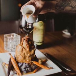 Vail Chophouse - SLOW COOKED PORK SHANK* (gf) creamy polenta, natural jus, asparagus