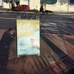Signage out front with hours of operation.