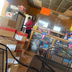 Poncho’s Pizza - Counter, and freezer stacked by boxes.