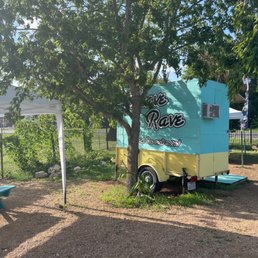 a blue and yellow trailer parked next to a picnic table
