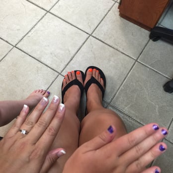 Folly Nails - My niece after her pedicure and nail painting. She loved the purple glitter. My orange toe nails and gel painted natural nails. - Nail Salons Near Me - Charleston, South Carolina