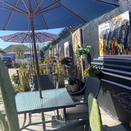 a patio with tables and chairs