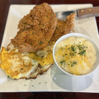 Scrambled - Fried pork chops, cheese grits and fried eggs - Breakfast & Brunch Near Me - McDonough, Georgia Scrambled - Fried pork chops, cheese grits and fried eggs - Breakfast & Brunch Near Me - McDonough, Georgia