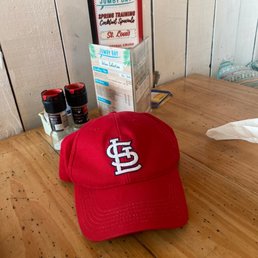 a st louis baseball cap on a table a st louis baseball cap on a table