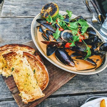 The Dawson - Mussels - gochujang, coconut milk, lemongrass, pickled fresno, charred lime, grilled miche - American Near Me - Chicago, Illinois The Dawson - Mussels - gochujang, coconut milk, lemongrass, pickled fresno, charred lime, grilled miche - American Near Me - Chicago, Illinois
