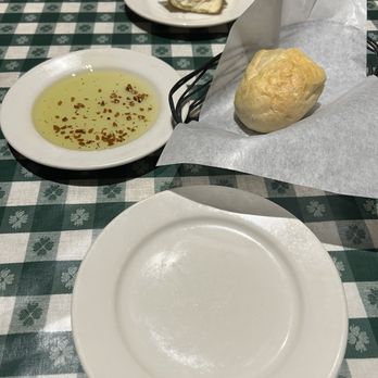 Johnny Carino's - Complementary warm bread with olive oil with garlic and herbs - Italian Near Me - Eastvale, California Johnny Carino's - Complementary warm bread with olive oil with garlic and herbs - Italian Near Me - Eastvale, California