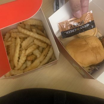 Dave's Hot Chicken - Slider (hot) and fries. Use sauce pack to reference how big the bun is. Chicken is long. - Chicken Shop Near Me - Oakland, California