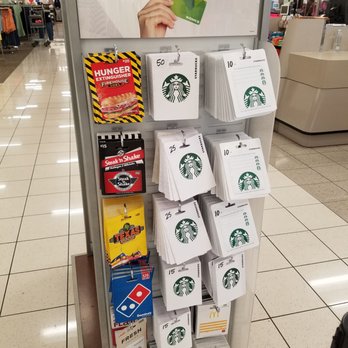 Kohl's - Gift Cards - The image shows a gift card display stand at Kohl's in Gilbert, AZ, featuring various gift cards including Starbucks, McDonald's, Domino's, Burger King, and others. The display has a sign at the top promoting Kohl's gift cards, with a hand holding a Kohl's card. The gift cards are arranged in rows, with some cards showing denominations such as $50, $25, $15, and $10. The background reveals the interior of Kohl's, with clothing racks and store fixtures visible. - Men's Clothing Near Me - Gilbert, Arizona
