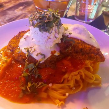 Pastabilities - Two crispy chicken Parmigiano filets on top of fettuccine with 50/50 sauce and topped with a soft cheese - Italian Near Me - Syracuse, New York Pastabilities - Two crispy chicken Parmigiano filets on top of fettuccine with 50/50 sauce and topped with a soft cheese - Italian Near Me - Syracuse, New York