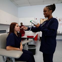 All-State Career - Medical Assisting student taking temperature of another student