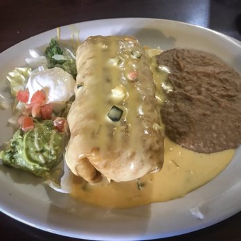 Coronas De Oro - Steak Chimichanga with chili con queso and refried beans - Mexican Near Me - Belton, Texas Coronas De Oro - Steak Chimichanga with chili con queso and refried beans - Mexican Near Me - Belton, Texas