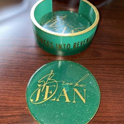 Custom coaster with business brand colors and logo.