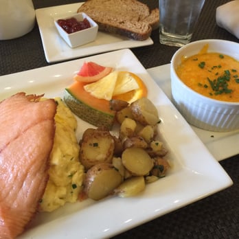 Café Muse - You're looking at a salmon scramble and seafood grits with cheddar. Yum! - Breakfast & Brunch Near Me - Royal Oak, Michigan