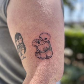 Family Dinner Studio - Memorial tattoo: Penguin drinking an iced coffee and Baby Baymax holding a cat - Tattoo Near Me - Huntington Beach, California Family Dinner Studio - Memorial tattoo: Penguin drinking an iced coffee and Baby Baymax holding a cat - Tattoo Near Me - Huntington Beach, California