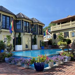 Pool area with guest houses in background