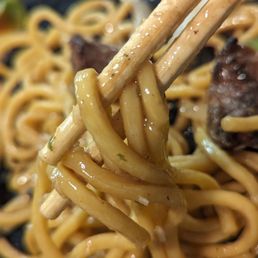 Garlic noodles with filet mignon - close up Garlic noodles with filet mignon - close up