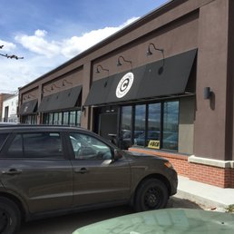 a car parked outside of a restaurant a car parked outside of a restaurant