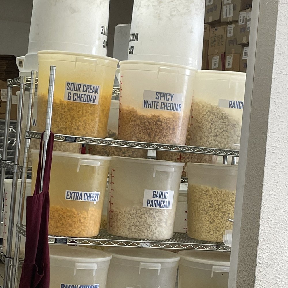 Legends Popcorn - a shelf full of buckets of popcorn - Popcorn Shops Near Me - Plano, Texas