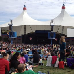 a crowd of people sitting on the grass